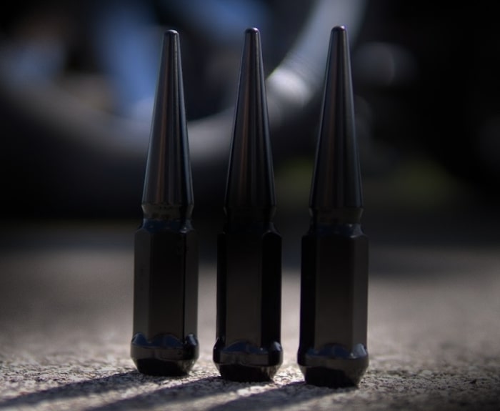 Black and chrome spiked lug nuts and spiked valve stem caps in multiple colors